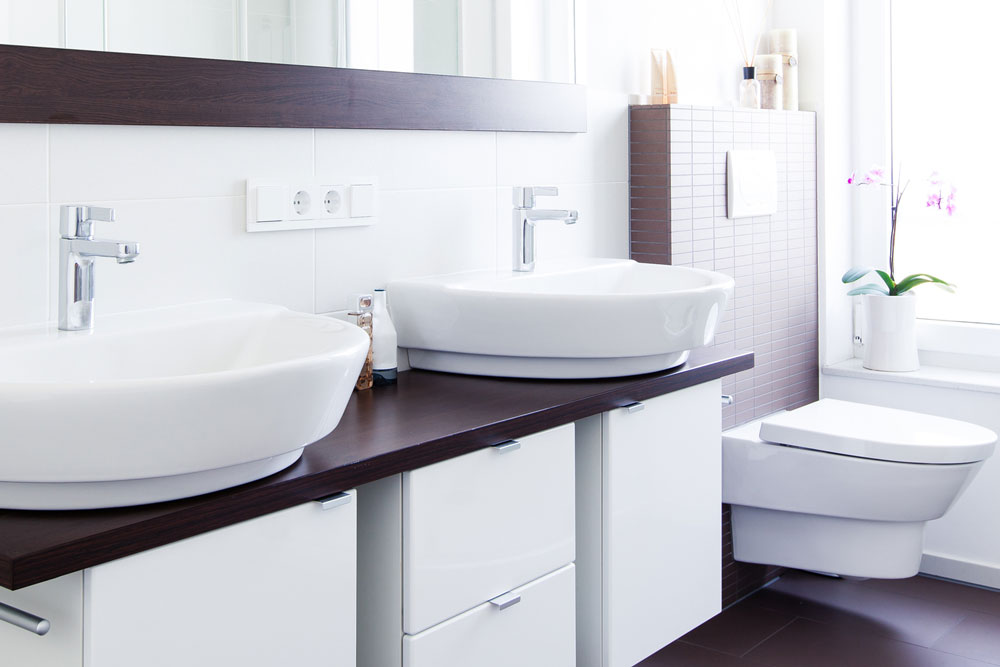 High End Bathroom with double sinks and wall mount toilet - Harris Plumbing